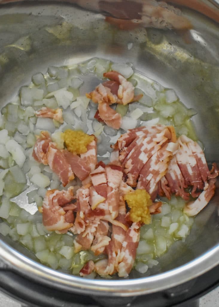 Add onions and bacon into instant pot